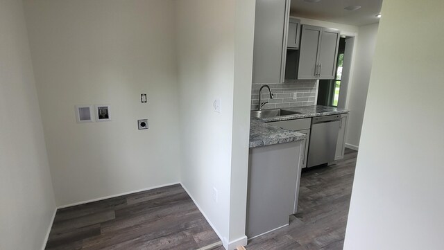 203 E Mill St, Athens, MI 49011 - laundry area with a sink, electric dryer hookup, dark wood-style flooring, and baseboards