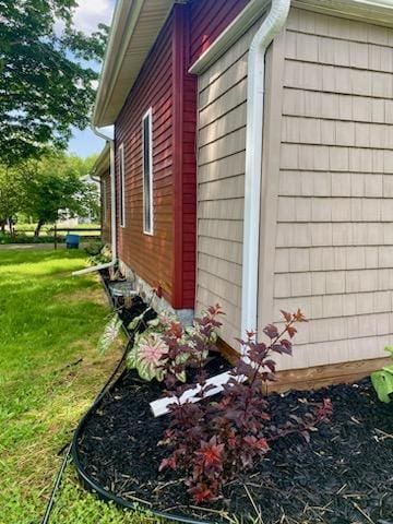 view of home's exterior with a lawn