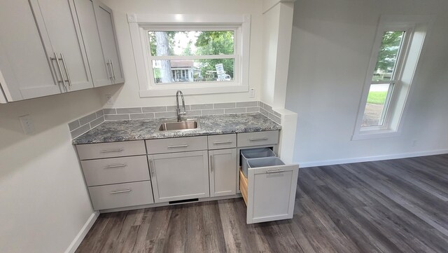 203 E Mill St, Athens, MI 49011 - kitchen with a sink, dark wood-style floors, light stone counters, and baseboards