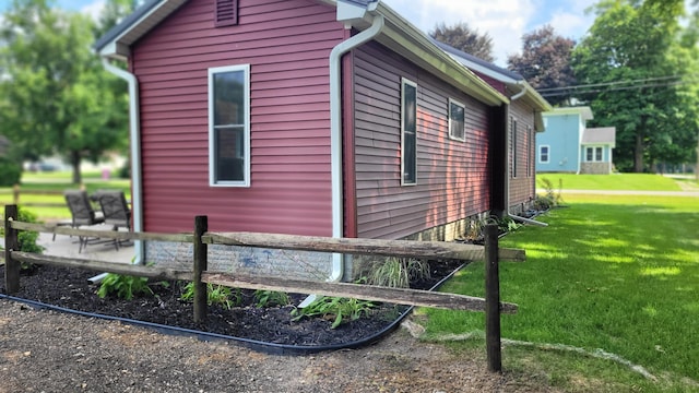 view of home's exterior with a lawn