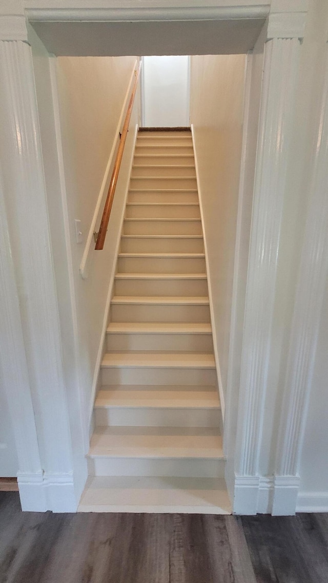 staircase with hardwood / wood-style floors