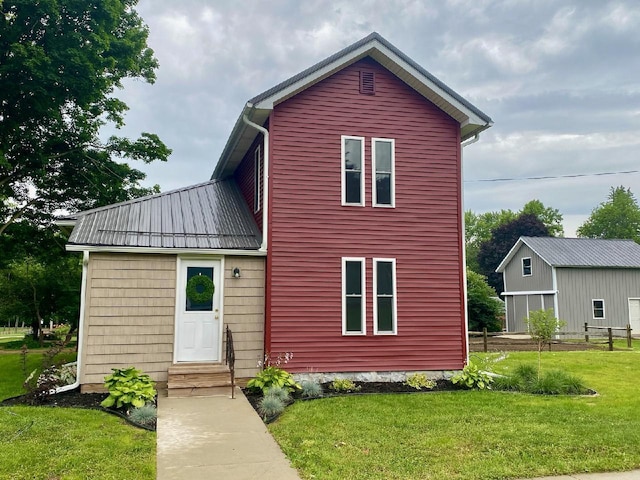 back of house with a yard