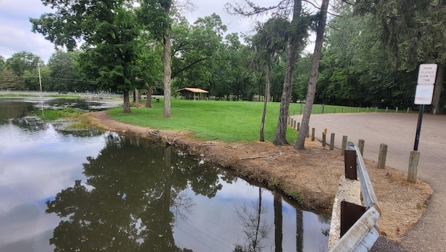 view of home's community featuring a yard and a water view