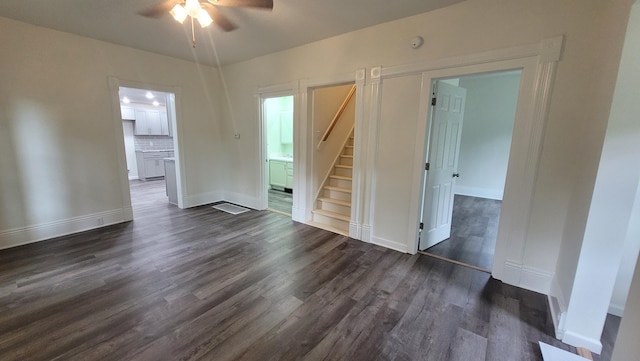 unfurnished room with ceiling fan and dark wood-type flooring