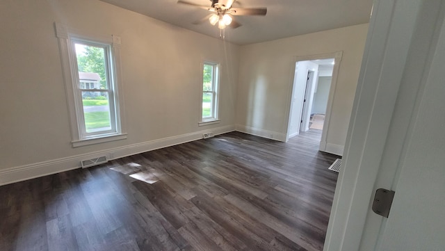 empty room with dark hardwood / wood-style floors and ceiling fan