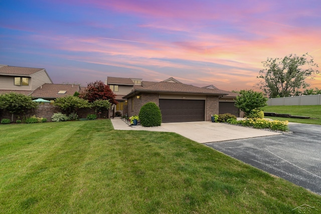 view of front of home featuring a yard and a garage