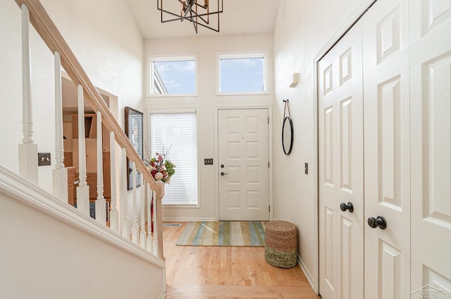 entrance foyer featuring hardwood / wood-style floors and a notable chandelier