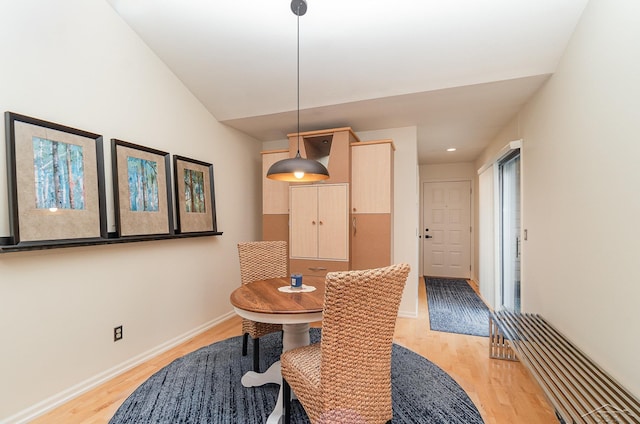 dining room featuring light hardwood / wood-style floors, a wealth of natural light, and lofted ceiling