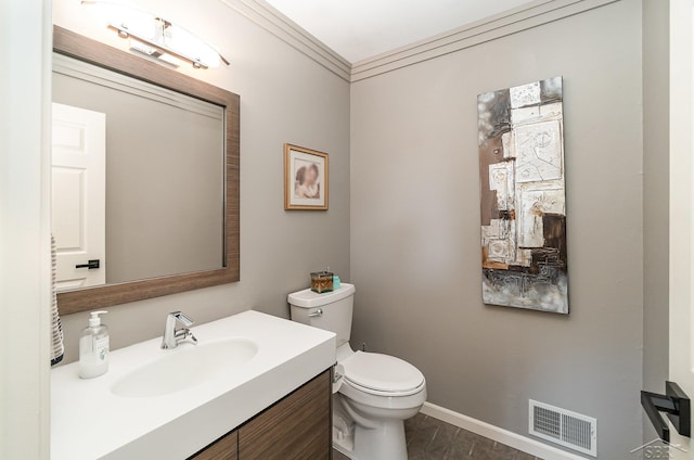 bathroom featuring vanity, toilet, and crown molding