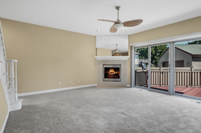 unfurnished living room featuring carpet flooring and ceiling fan