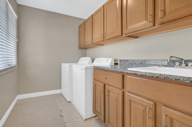 laundry area featuring sink, light tile patterned floors, cabinets, and independent washer and dryer