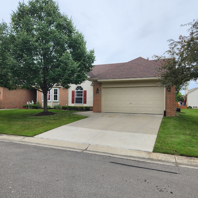 ranch-style home featuring a front lawn and a garage