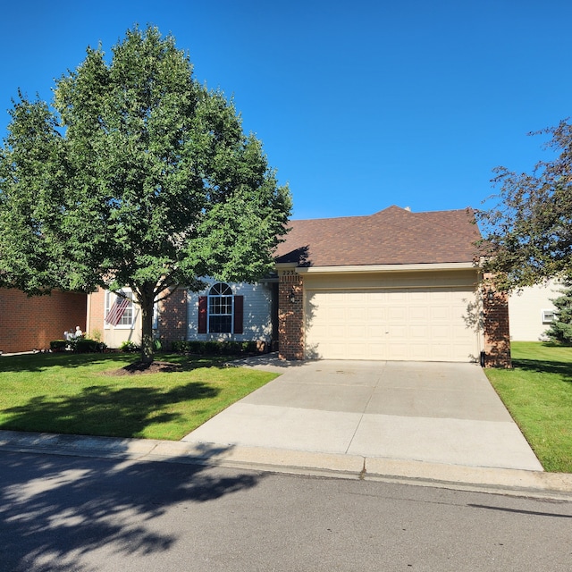 view of front of property with a front yard and a garage