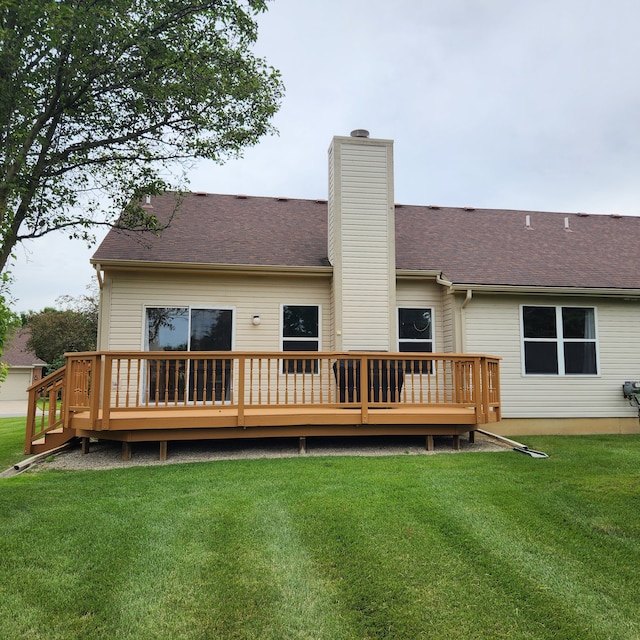 back of house with a lawn and a deck