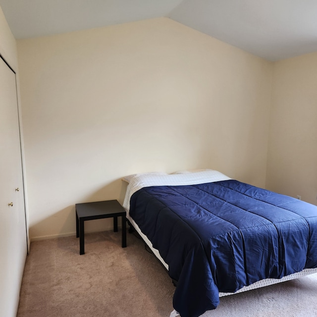 bedroom featuring carpet flooring and vaulted ceiling