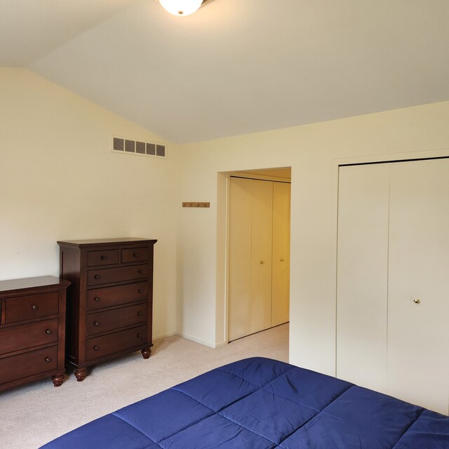 2233 Maplehurst Dr, Walled Lake, MI 48390 - bedroom with vaulted ceiling and light colored carpet