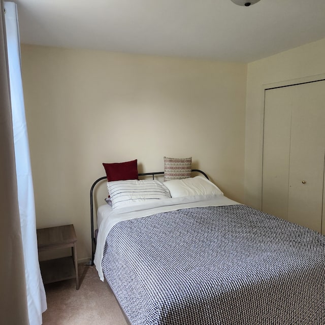 carpeted bedroom featuring a closet