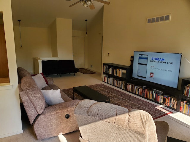 living room with carpet flooring, ceiling fan, and vaulted ceiling