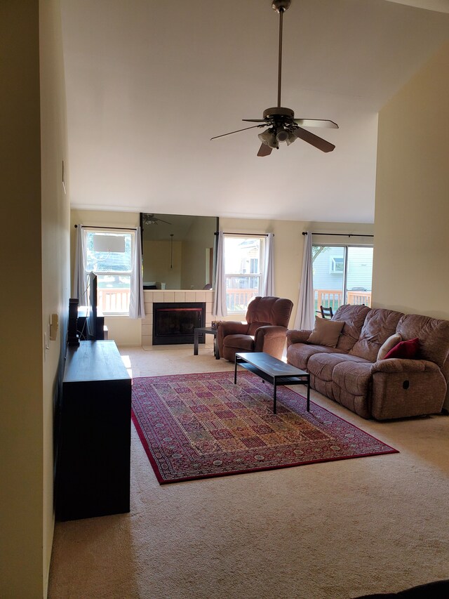 2233 Maplehurst Dr, Walled Lake, MI 48390 - carpeted living room featuring a ceiling fan, healthy amount of natural light, a fireplace, and vaulted ceiling