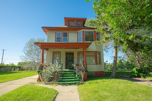 view of front of property featuring a front yard and a porch