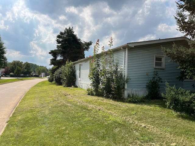 view of side of home featuring a yard