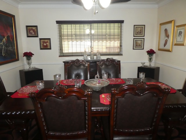 dining space featuring crown molding