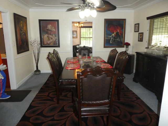 dining space featuring carpet flooring, ceiling fan with notable chandelier, and ornamental molding