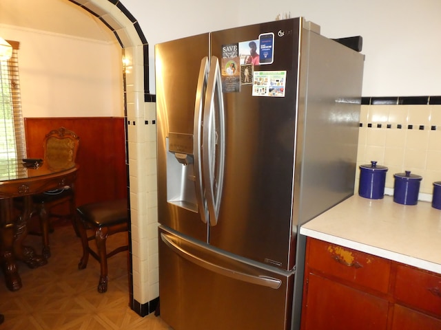 kitchen featuring stainless steel refrigerator with ice dispenser