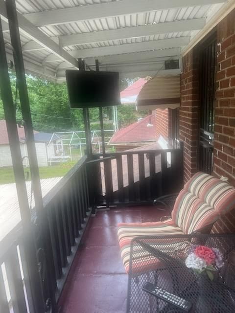 sunroom featuring beam ceiling