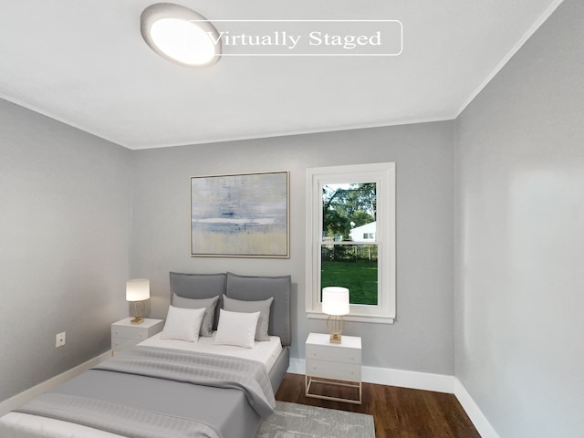 bedroom with wood-type flooring and ornamental molding