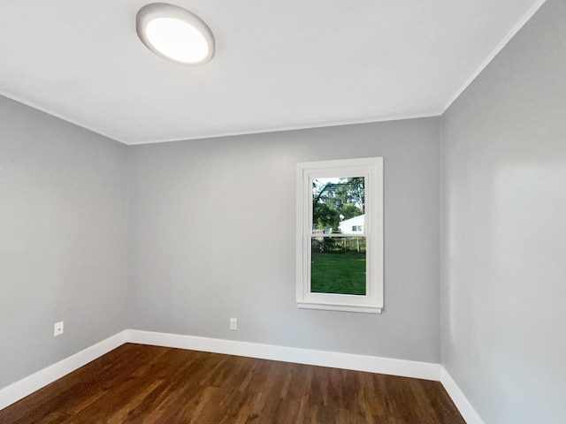 100 E Kalama Ave, Madison Heights, MI 48071 - spare room featuring baseboards, dark wood-style floors, and crown molding