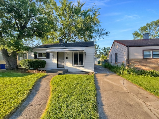 bungalow-style house featuring a front yard