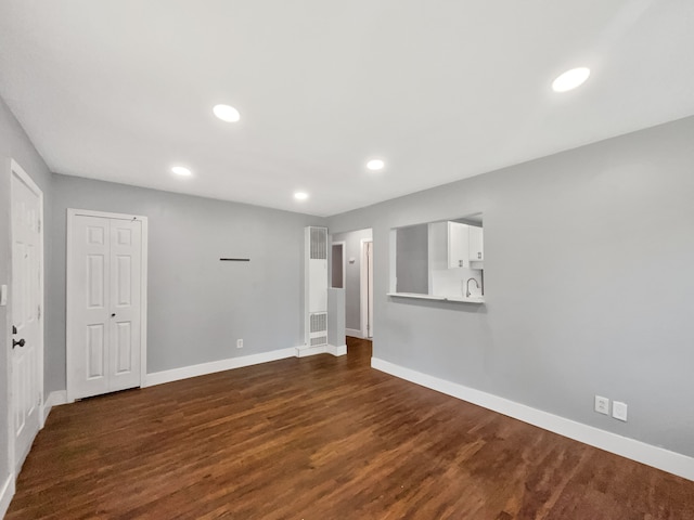 100 E Kalama Ave, Madison Heights, MI 48071 - empty room with baseboards, dark wood-style floors, a heating unit, and recessed lighting