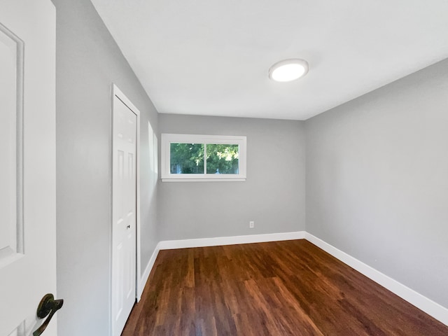 100 E Kalama Ave, Madison Heights, MI 48071 - unfurnished bedroom with dark wood-type flooring and baseboards