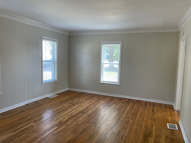 unfurnished room with plenty of natural light, dark hardwood / wood-style floors, and crown molding