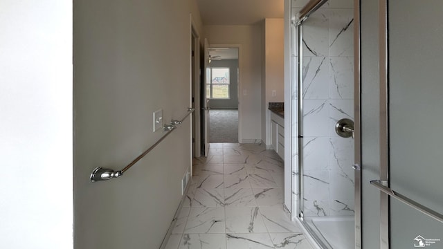 bathroom with vanity and a shower with door