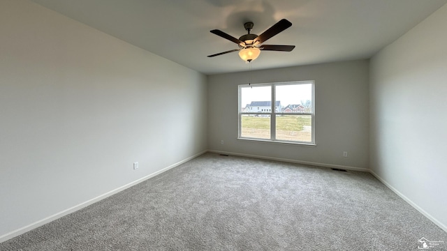 carpeted spare room with ceiling fan