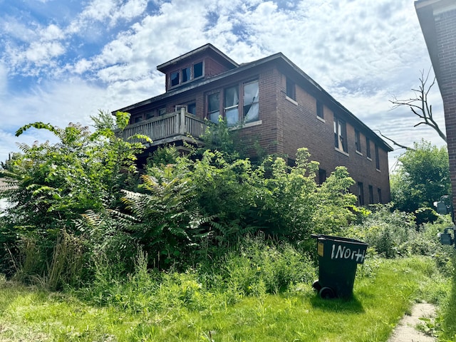 view of home's exterior with a balcony