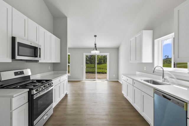 31433 Augusta Dr Unit 75, Romulus, MI 48174 - kitchen with stainless steel appliances, dark wood finished floors, lofted ceiling, white cabinets, and light countertops