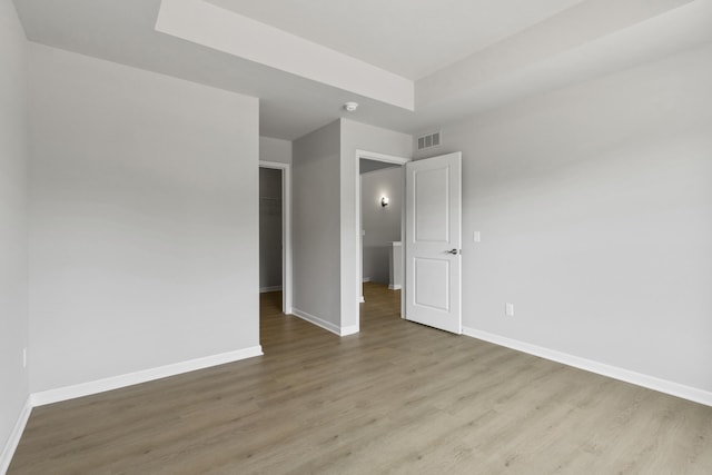 31421 Augusta Dr Unit 76, Romulus, MI 48174 - unfurnished bedroom featuring wood finished floors, a spacious closet, and a closet