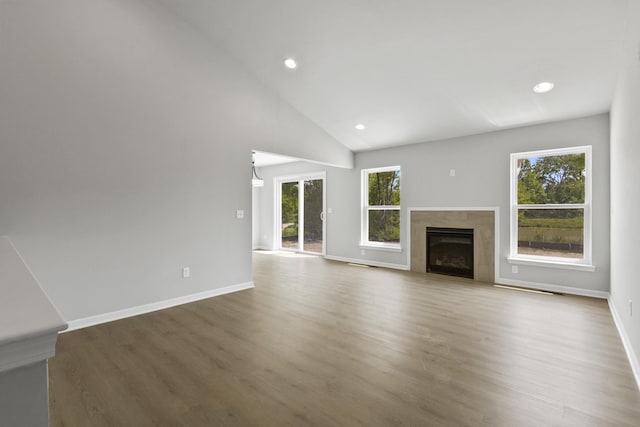 31421 Augusta Dr Unit 76, Romulus, MI 48174 - unfurnished living room with plenty of natural light, a premium fireplace, wood finished floors, recessed lighting, and vaulted ceiling