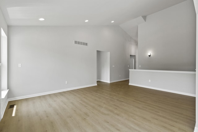 31421 Augusta Dr Unit 76, Romulus, MI 48174 - unfurnished room with light wood-type flooring, high vaulted ceiling, and recessed lighting