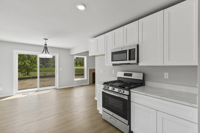 31421 Augusta Dr Unit 76, Romulus, MI 48174 - kitchen featuring appliances with stainless steel finishes, white cabinets, and decorative light fixtures