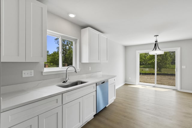 31421 Augusta Dr Unit 76, Romulus, MI 48174 - kitchen with dishwasher, white cabinetry, light stone countertops, hanging light fixtures, and light wood finished floors