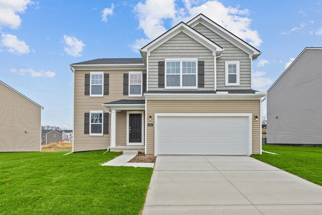 view of front of property featuring a garage and a front yard