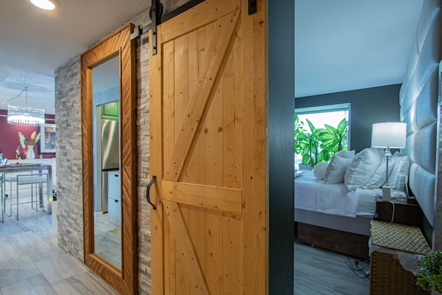 hall with a notable chandelier and a barn door