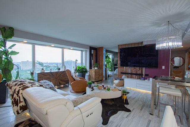 living room featuring a chandelier and light hardwood / wood-style flooring