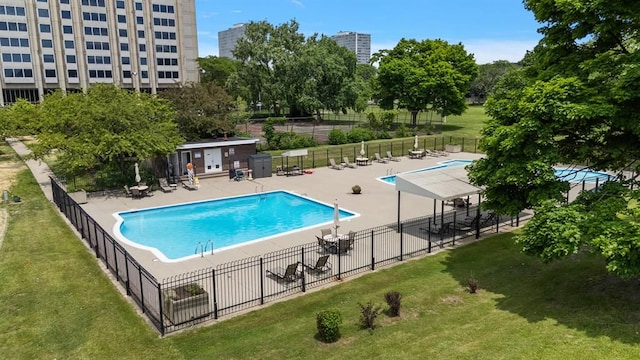 view of swimming pool featuring a patio area and a lawn