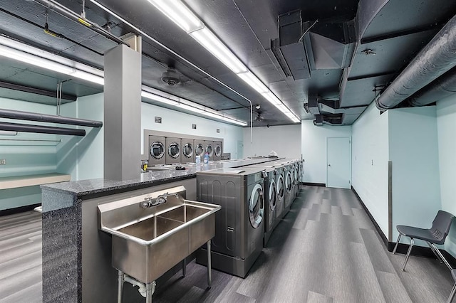 washroom with dark hardwood / wood-style floors and washing machine and clothes dryer