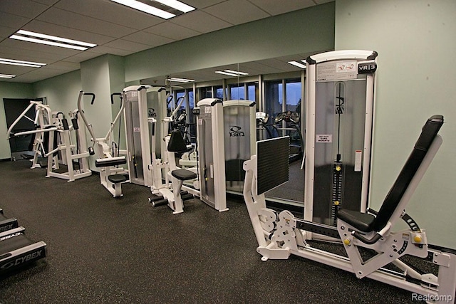 gym with a paneled ceiling